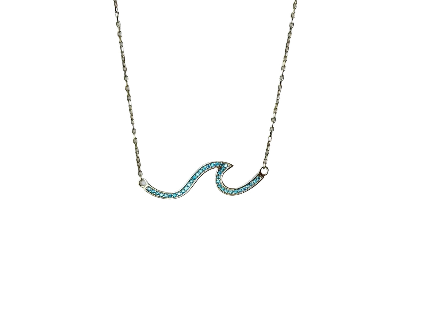 A necklace with a blue gemstone pendant in the shape of a wave.