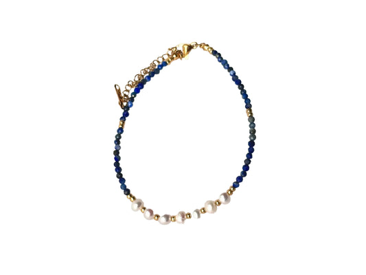 A necklace with blue and white beads, accented by gold-colored beads and pearls.