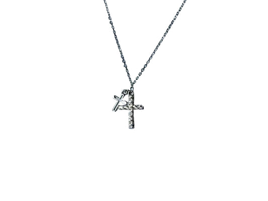 A silver cross pendant with a small charm attached to it.