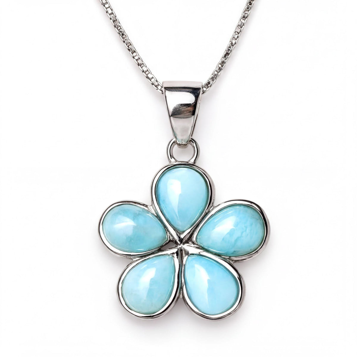 A silver necklace with a pendant featuring a blue gemstone in the shape of a flower.