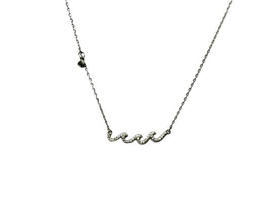 A silver necklace with a cursive pendant.