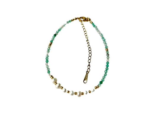 A necklace with green and white beads, white pearls, and a gold clasp.
