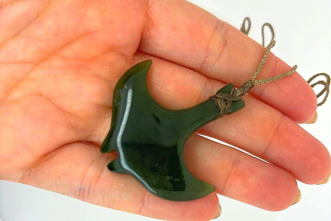 a person holding a green object in their hand