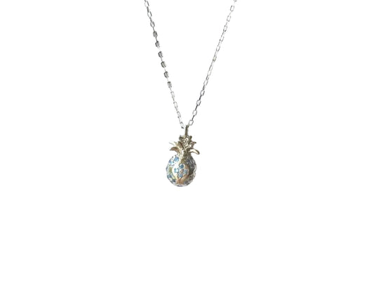 A silver necklace with a pendant in the shape of a pineapple.