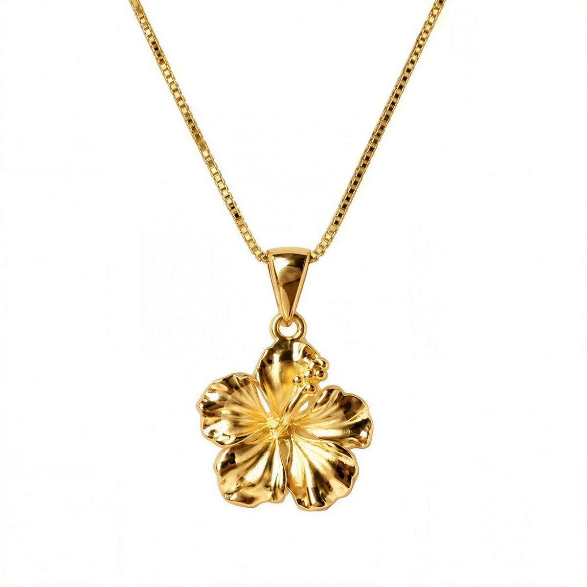 A gold-colored pendant necklace with a large, intricately designed flower pendant.