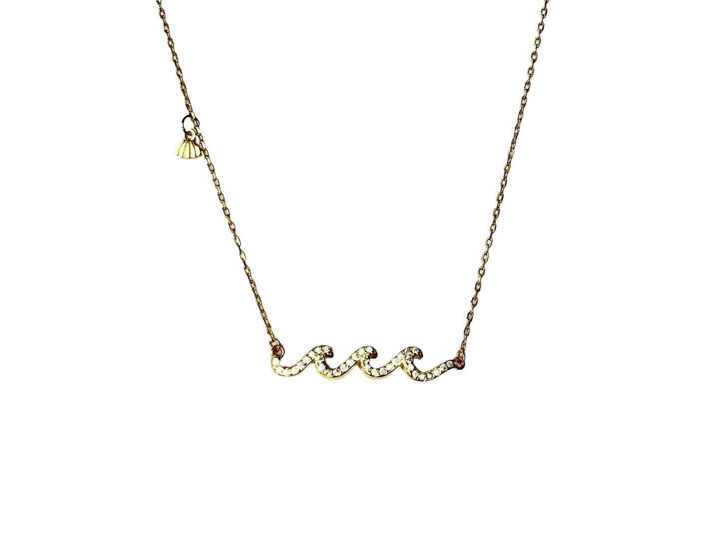 A gold necklace with a pendant in the shape of a wave.