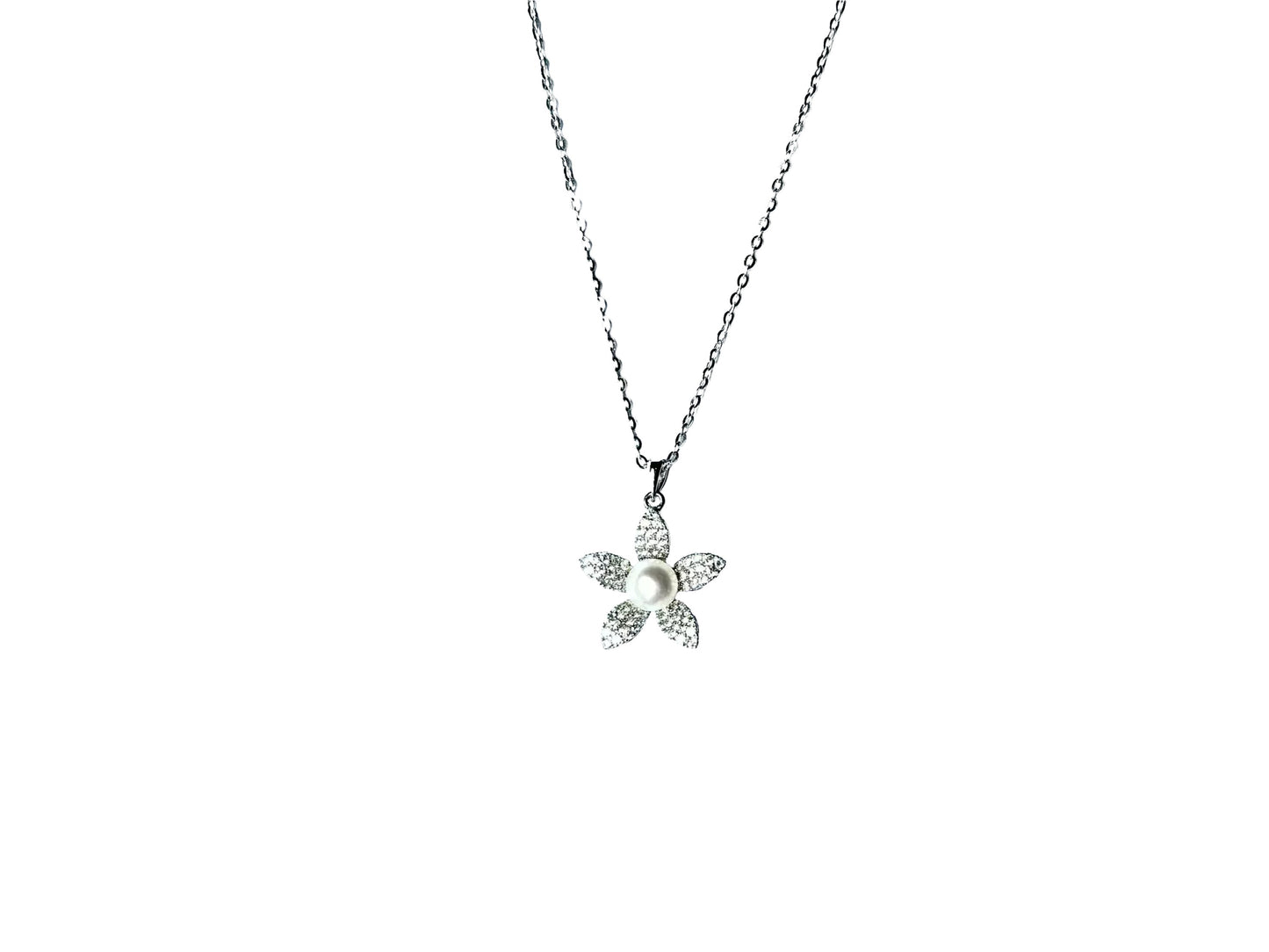 A silver necklace with a small flower pendant is shown against a white background.