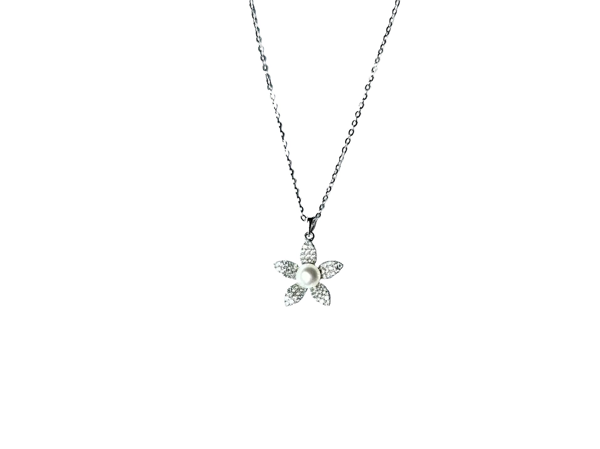 A silver necklace with a small flower pendant is shown against a white background.