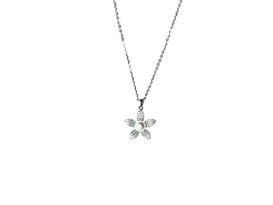 A silver necklace with a small flower pendant is shown against a white background.