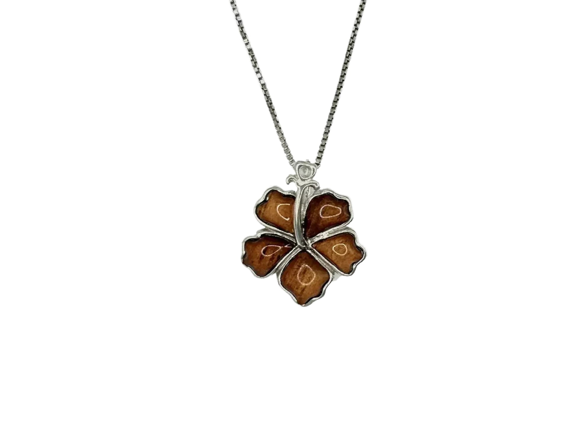 A silver necklace with a pendant in the shape of a brown flower.