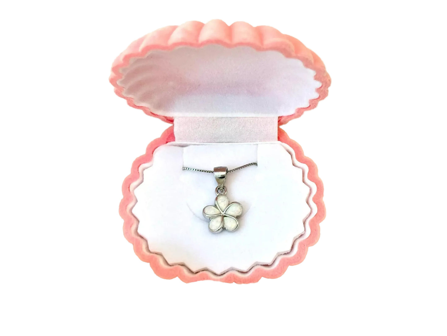 A pink-colored jewelry box containing a silver necklace with a white flower pendant.