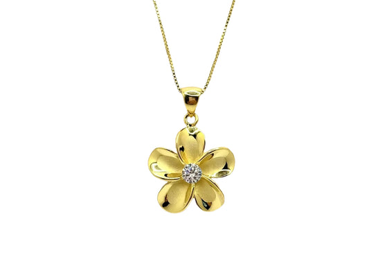 A gold-colored pendant necklace with a large, intricately designed flower-shaped pendant featuring a gemstone in the center.