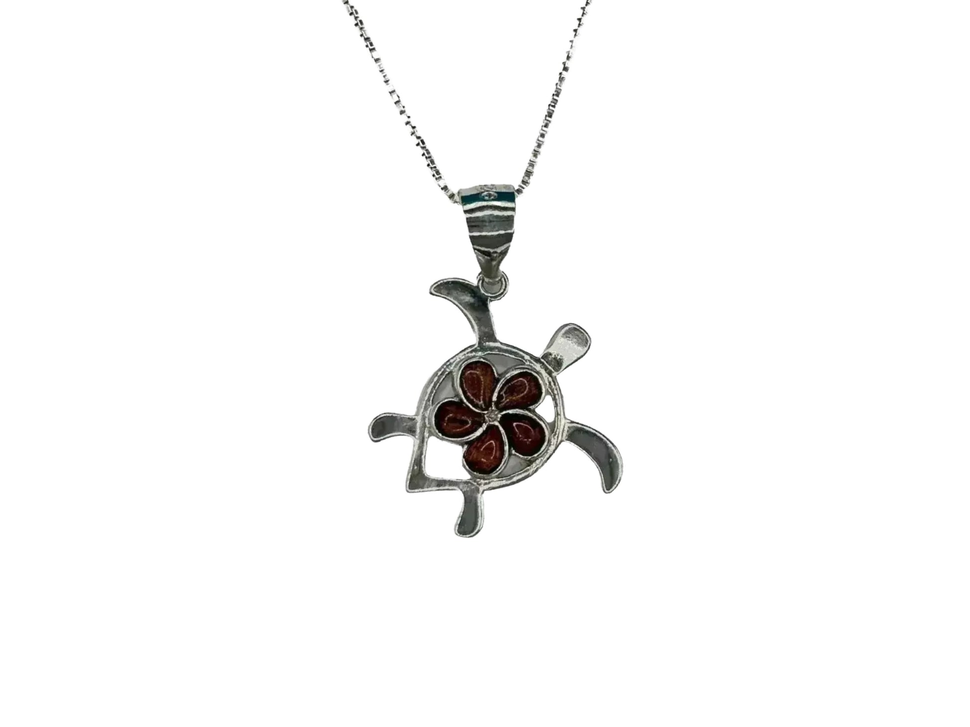 A silver necklace with a pendant in the shape of a flower.