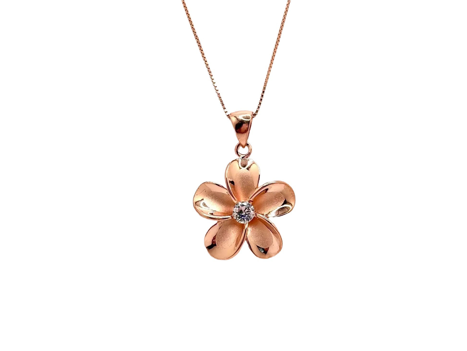 A delicate gold-colored pendant necklace with a single, intricately designed flower-shaped charm featuring a small gemstone at its center.