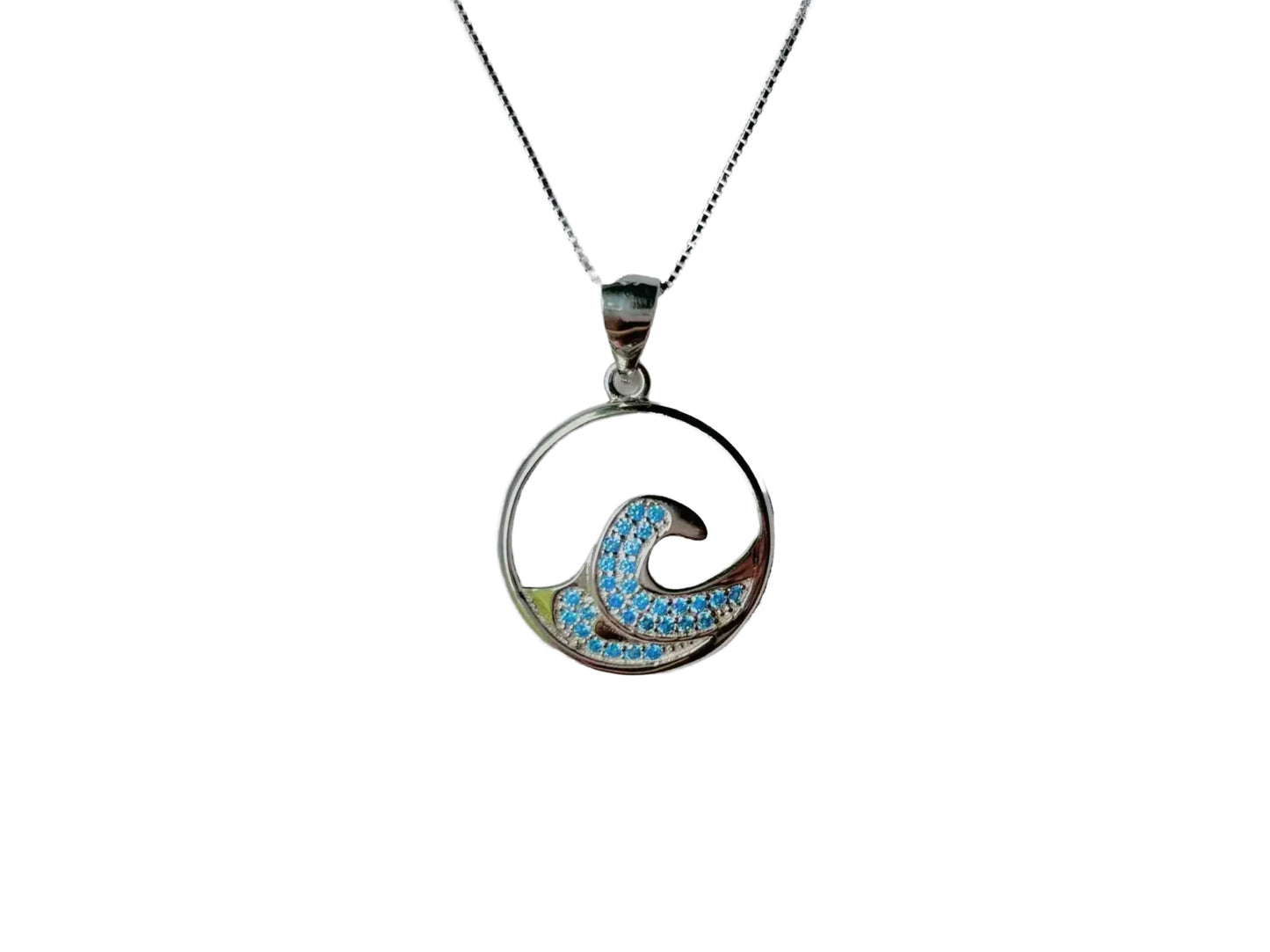 A silver pendant necklace with a circular design featuring a blue wave pattern and sparkling stones.