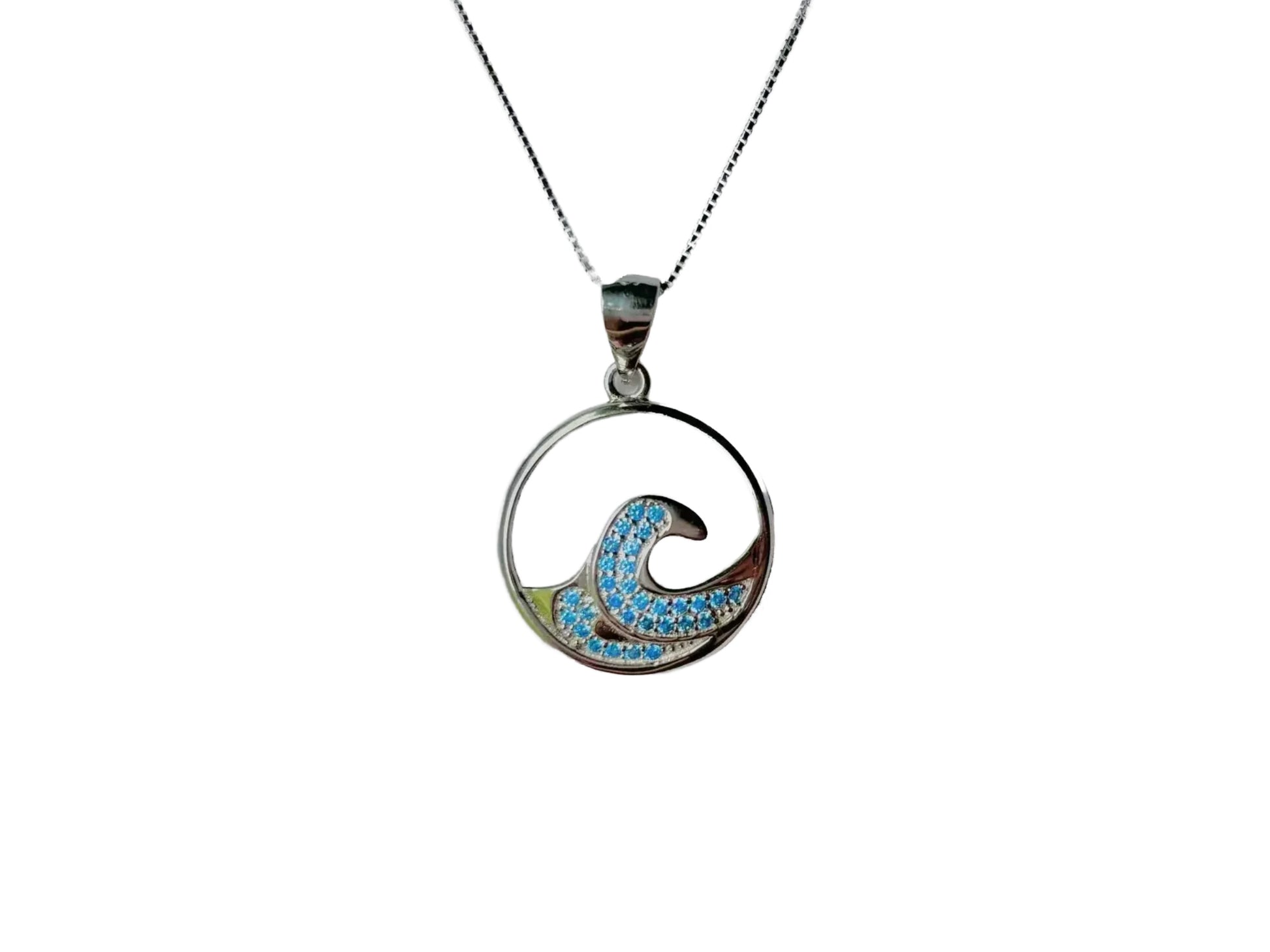 A silver pendant necklace with a circular design featuring a blue wave pattern and sparkling stones.
