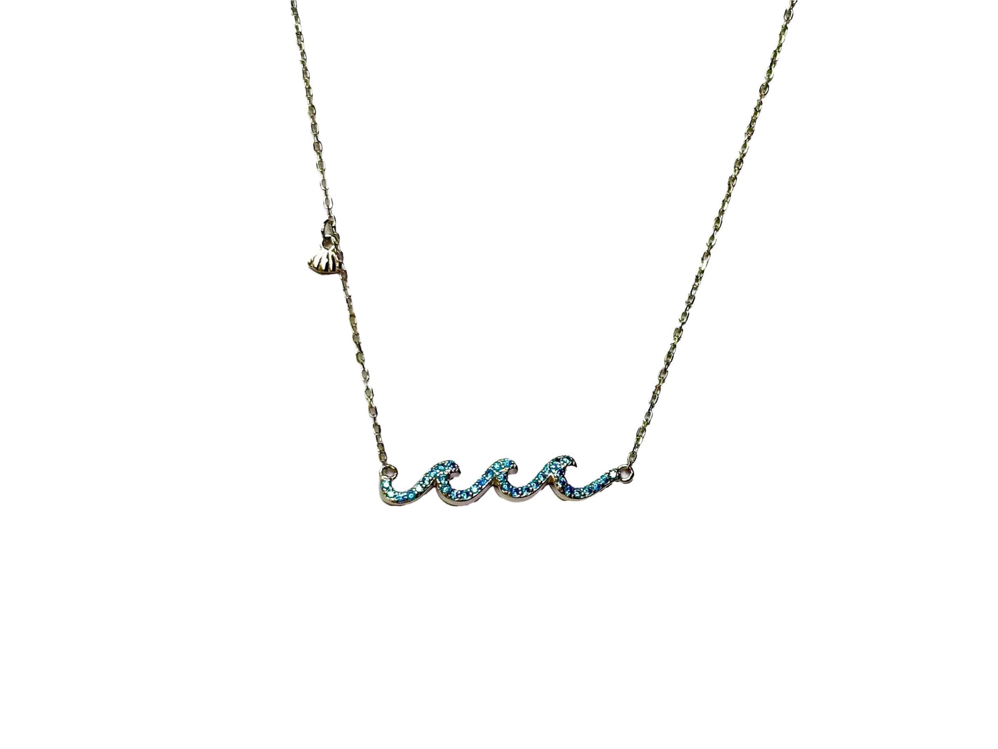 A necklace with a pendant in the shape of a wave, made of metal and adorned with blue gemstones.