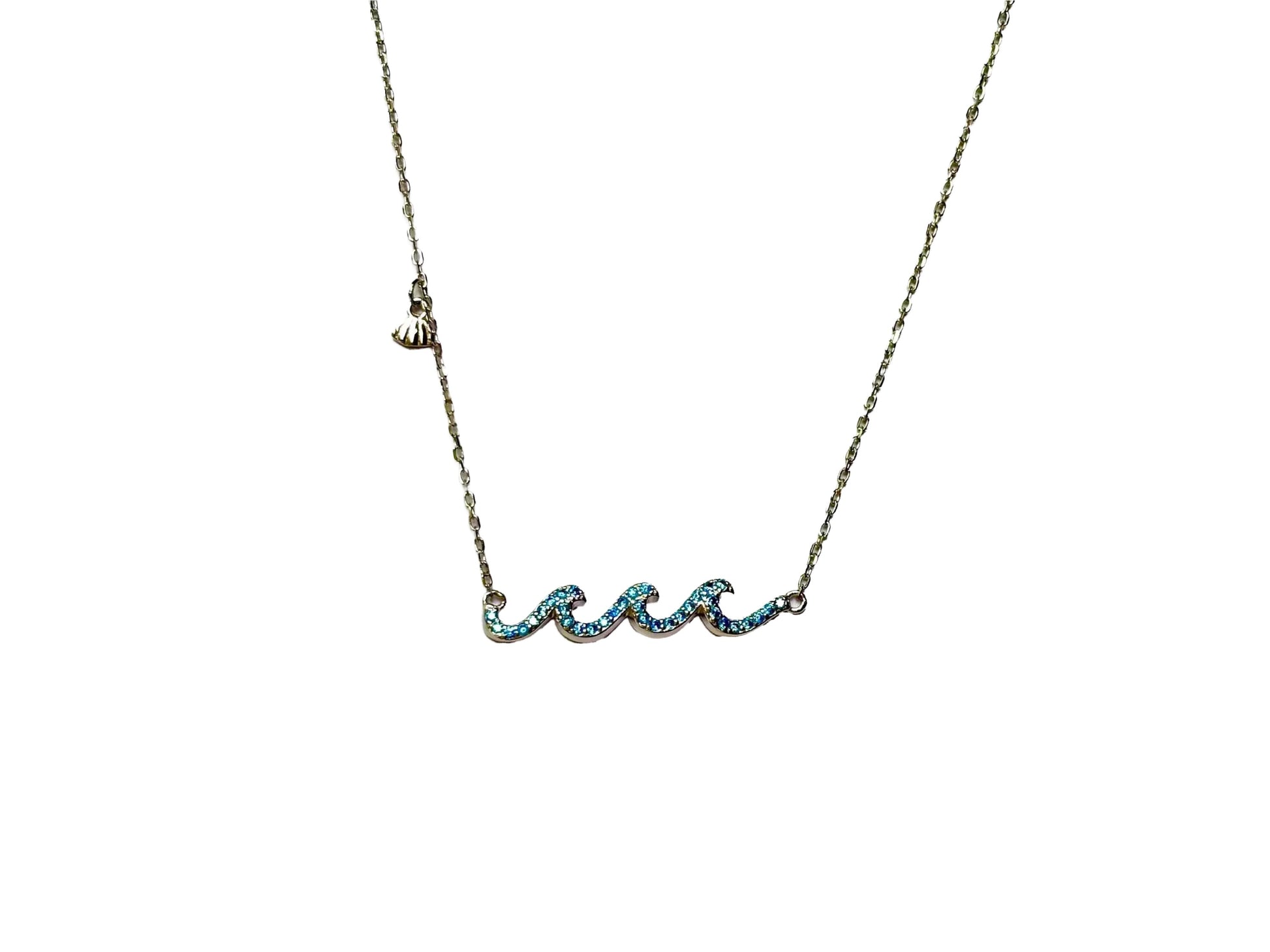 A necklace with a pendant in the shape of a wave, made of metal and adorned with blue gemstones.